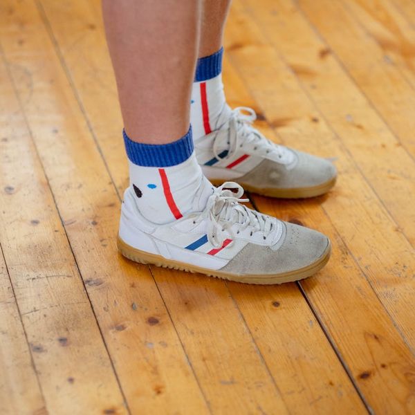 Close-up of comfortable sports shoes on a wooden floor.